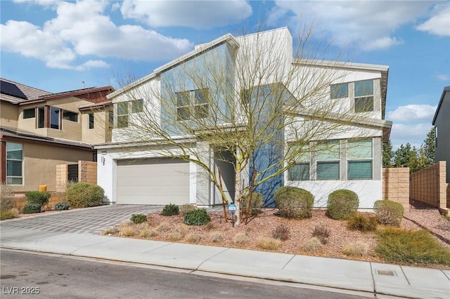 view of front of property with a garage, decorative driveway, and stucco siding