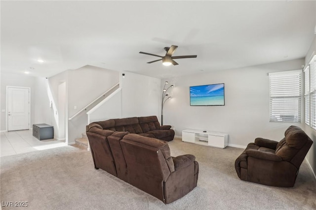 9690 Hiking Ave, Las Vegas, NV 89166 - living room with light carpet, ceiling fan, stairs, and baseboards
