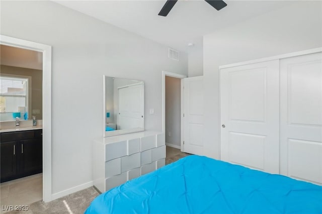 9690 Hiking Ave, Las Vegas, NV 89166 - bedroom with a closet, light colored carpet, visible vents, connected bathroom, and baseboards