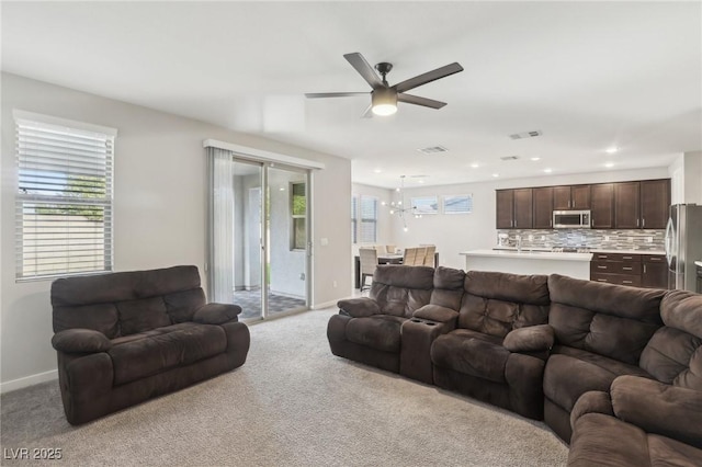 9690 Hiking Ave, Las Vegas, NV 89166 - living room with light carpet, plenty of natural light, and visible vents