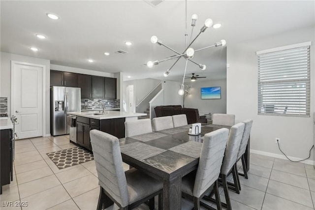9690 Hiking Ave, Las Vegas, NV 89166 - dining room with light tile patterned floors, recessed lighting, visible vents, stairway, and baseboards