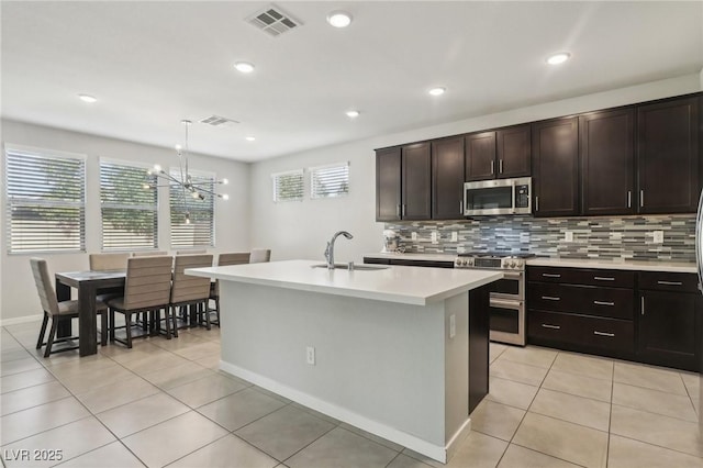 9690 Hiking Ave, Las Vegas, NV 89166 - kitchen featuring stainless steel appliances, pendant lighting, light countertops, and a sink