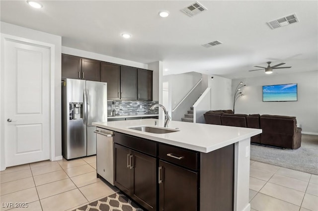 9690 Hiking Ave, Las Vegas, NV 89166 - kitchen featuring stainless steel appliances, light countertops, open floor plan, a sink, and an island with sink
