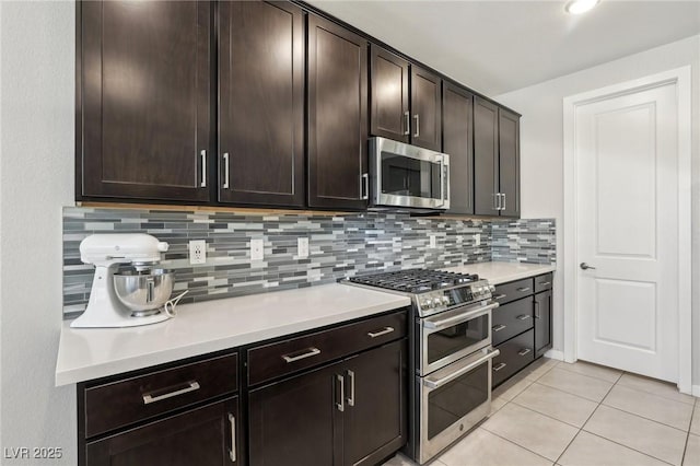 9690 Hiking Ave, Las Vegas, NV 89166 - kitchen featuring stainless steel appliances, light countertops, dark brown cabinets, and tasteful backsplash