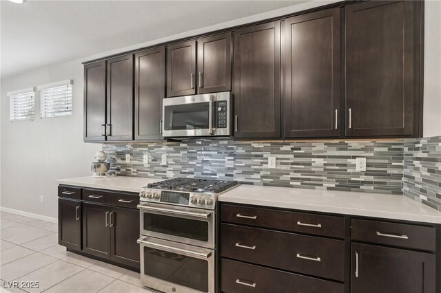 9690 Hiking Ave, Las Vegas, NV 89166 - kitchen with appliances with stainless steel finishes, light countertops, dark brown cabinetry, and light tile patterned floors