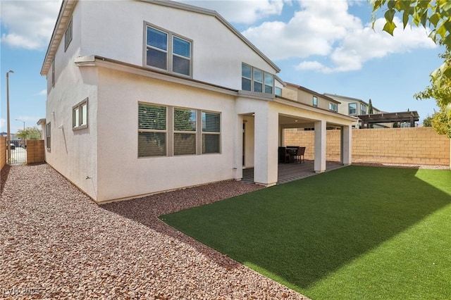 9690 Hiking Ave, Las Vegas, NV 89166 - back of property with a yard, a patio area, a fenced backyard, and stucco siding