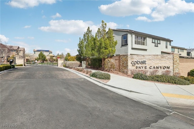 9690 Hiking Ave, Las Vegas, NV 89166 - view of street featuring a residential view, curbs, and a gated entry
