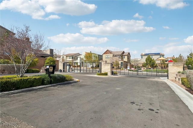 9690 Hiking Ave, Las Vegas, NV 89166 - view of road with a gate, a residential view, a gated entry, and curbs