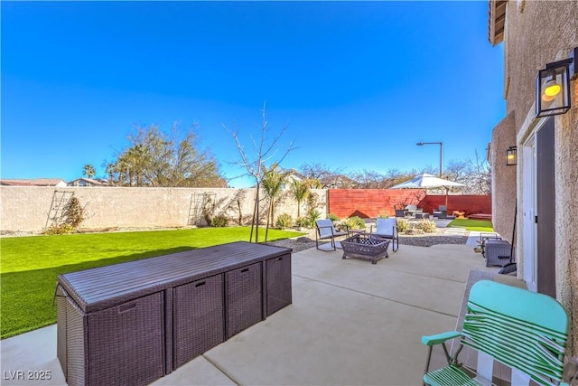 view of patio / terrace featuring an outdoor fire pit