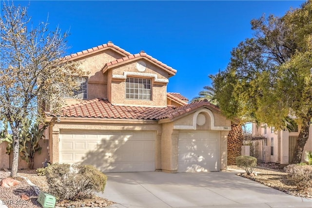 mediterranean / spanish-style house with a garage