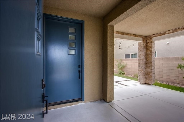 property entrance featuring a patio