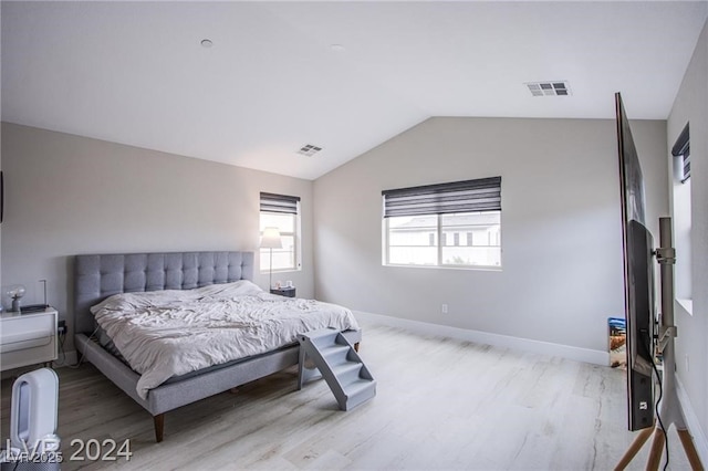 bedroom featuring vaulted ceiling and light hardwood / wood-style flooring