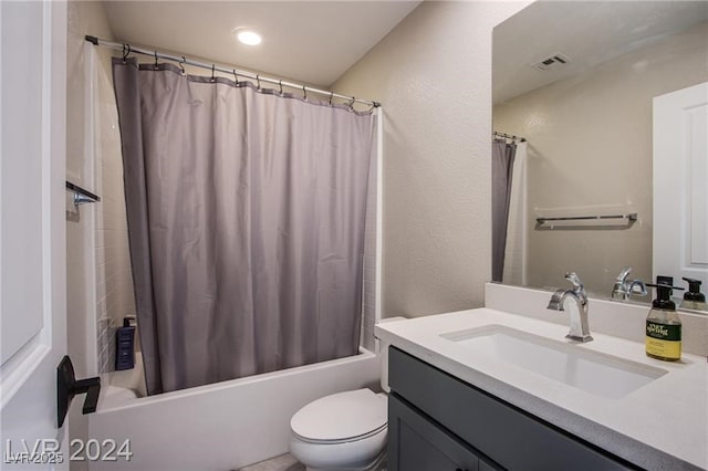 full bathroom featuring shower / bath combo, vanity, and toilet