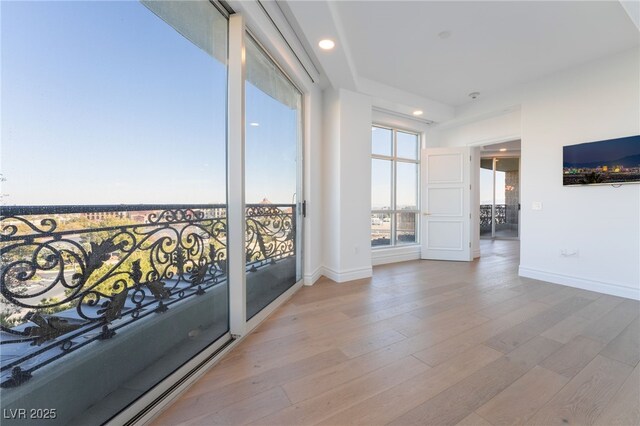 interior space with light wood-type flooring, baseboards, and recessed lighting