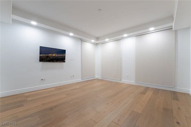 unfurnished room featuring baseboards, light wood-style flooring, and recessed lighting