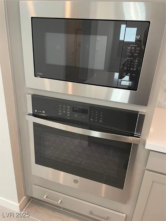 details featuring appliances with stainless steel finishes and white cabinetry