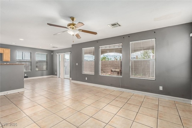 spare room with light tile patterned flooring and ceiling fan