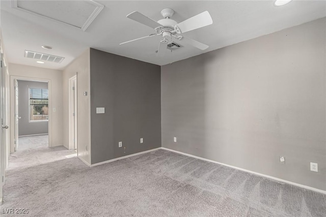 carpeted spare room featuring ceiling fan