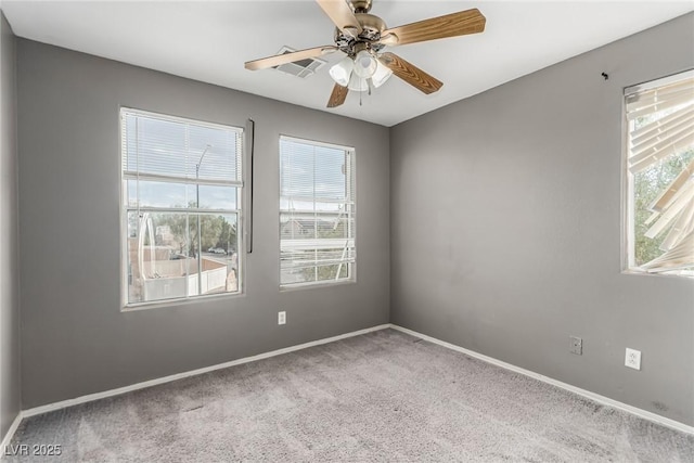 empty room featuring ceiling fan and carpet floors