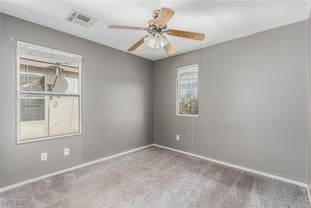 empty room with ceiling fan and carpet flooring