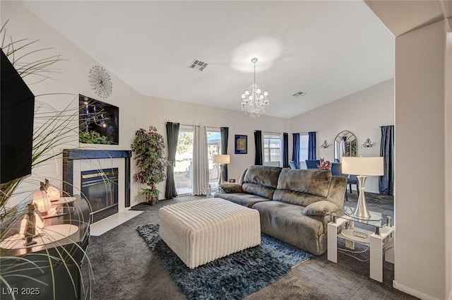 carpeted living room featuring an inviting chandelier, visible vents, and a tiled fireplace