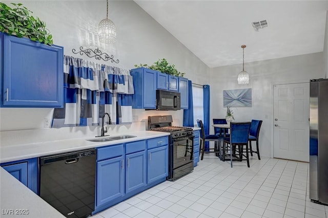 kitchen featuring light countertops, a sink, hanging light fixtures, and black appliances