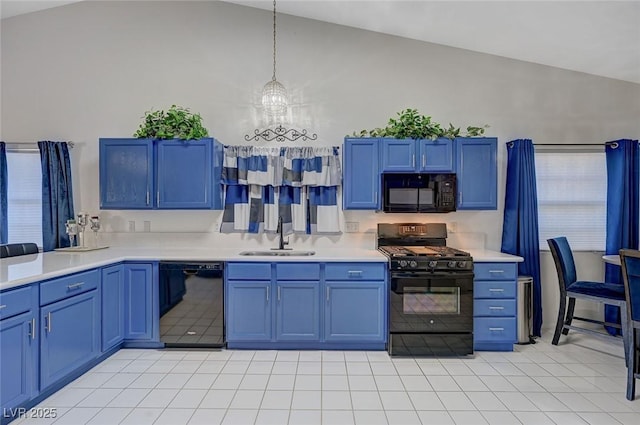 kitchen with blue cabinets, a sink, light countertops, black appliances, and pendant lighting