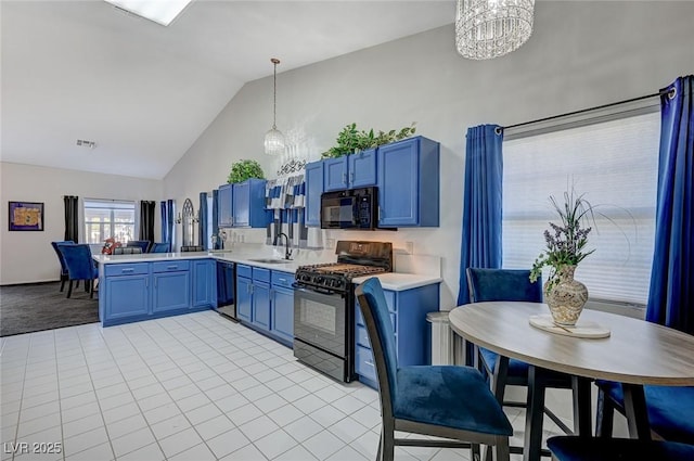 kitchen featuring hanging light fixtures, black appliances, light countertops, and a notable chandelier