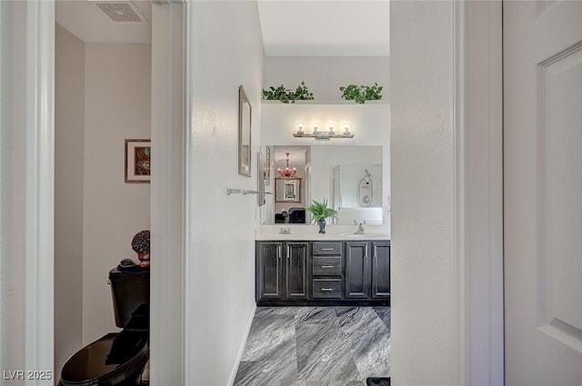 full bath featuring visible vents, a sink, and double vanity