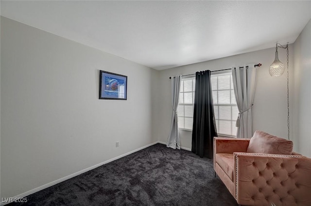 unfurnished room featuring dark carpet and baseboards