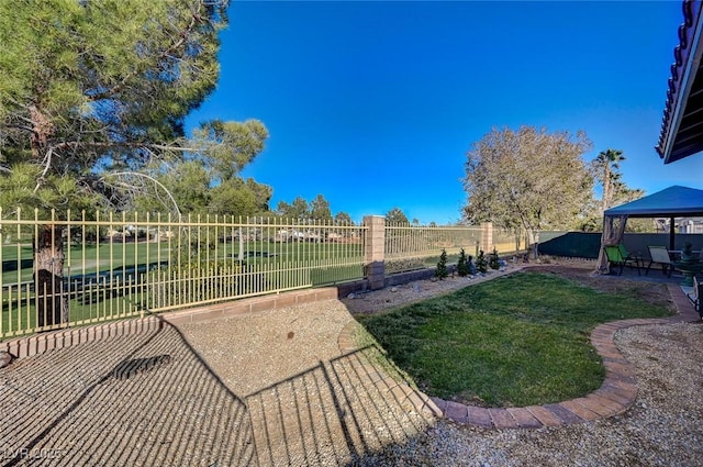 exterior space featuring a gazebo, a patio area, and a fenced backyard