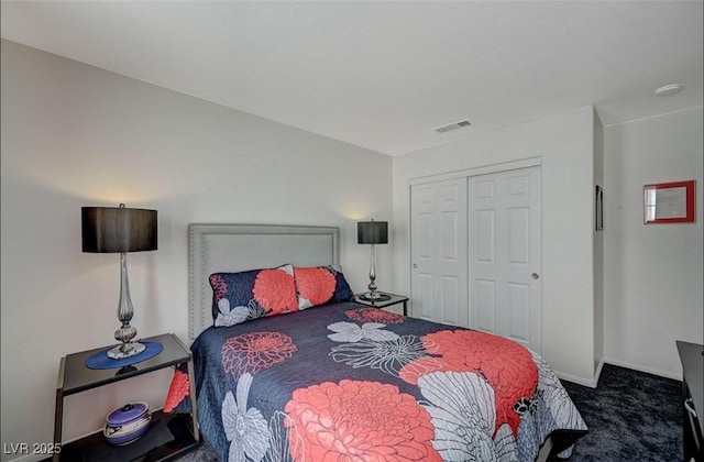 bedroom featuring dark colored carpet, a closet, visible vents, and baseboards