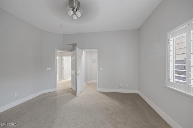 unfurnished bedroom with a ceiling fan, baseboards, and carpet flooring