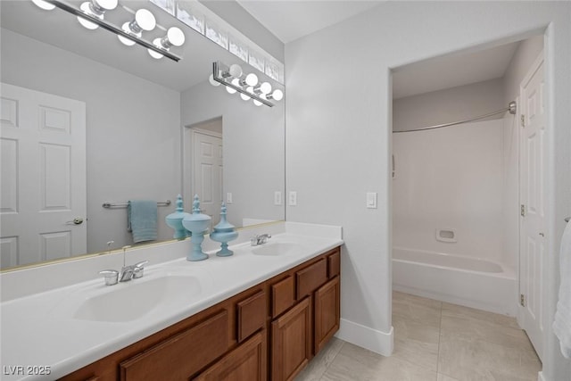 bathroom with double vanity, shower / bath combination, tile patterned flooring, and a sink