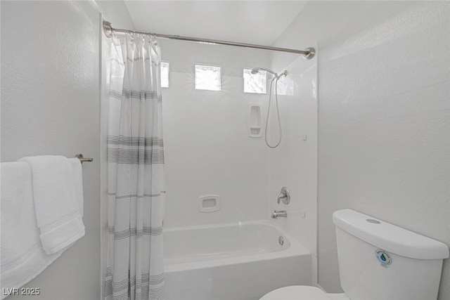 full bathroom featuring shower / bath combo and toilet