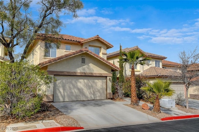 mediterranean / spanish-style home with a garage