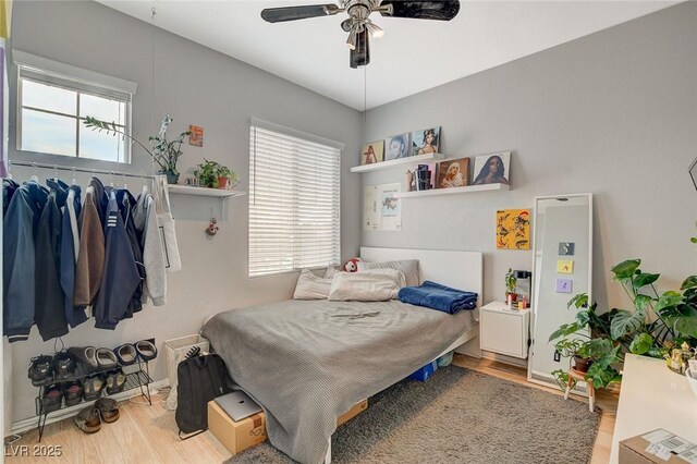 bedroom featuring multiple windows, ceiling fan, and light hardwood / wood-style floors