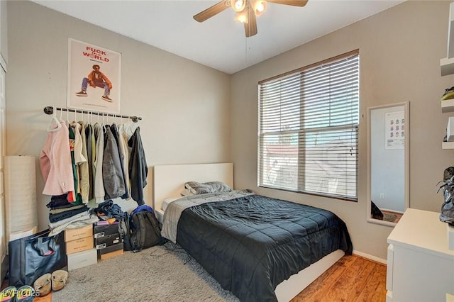 bedroom with light hardwood / wood-style floors and ceiling fan