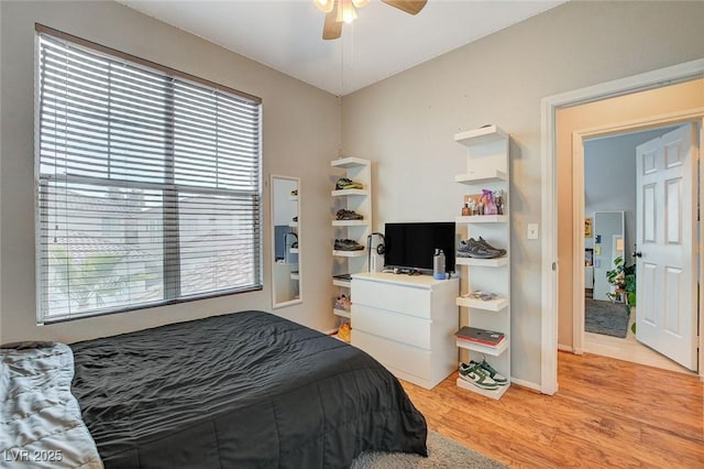 bedroom with light hardwood / wood-style floors and ceiling fan