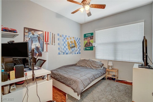 bedroom featuring hardwood / wood-style flooring and ceiling fan