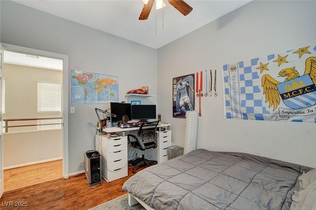 bedroom with ceiling fan and wood-type flooring