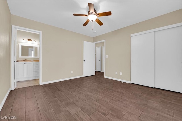 unfurnished bedroom with dark hardwood / wood-style flooring, ensuite bath, sink, a closet, and ceiling fan