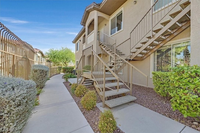 exterior space with fence and stucco siding