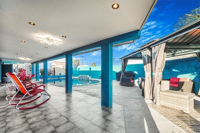 view of patio / terrace featuring ceiling fan, a gazebo, and a fenced in pool