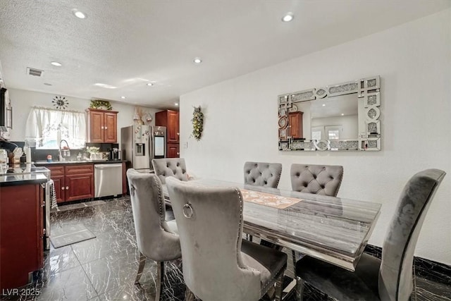 dining space with a textured ceiling, marble finish floor, visible vents, and recessed lighting