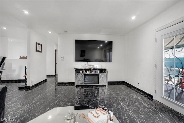 living room featuring recessed lighting, marble finish floor, and baseboards