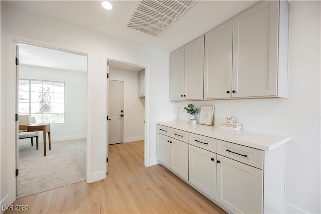 kitchen featuring white cabinetry and light hardwood / wood-style floors