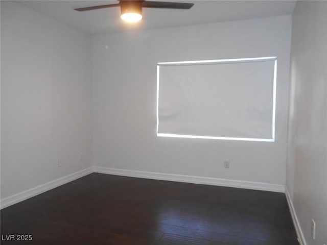 spare room featuring ceiling fan and dark wood-type flooring