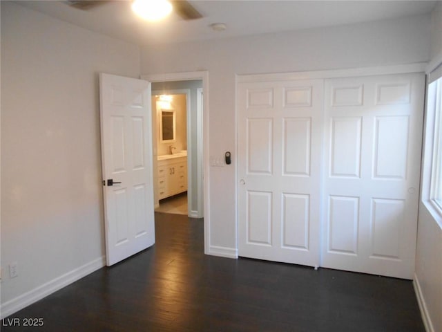 unfurnished bedroom featuring ceiling fan, dark wood-type flooring, and a closet