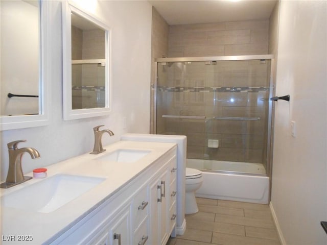 full bathroom featuring enclosed tub / shower combo, vanity, toilet, and tile patterned floors